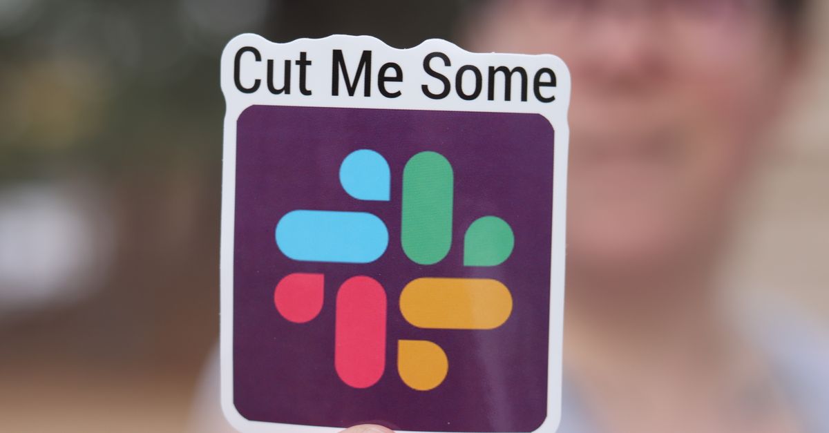 Close-up of a vibrant sticker with text 'Cut Me Some' held by a person.